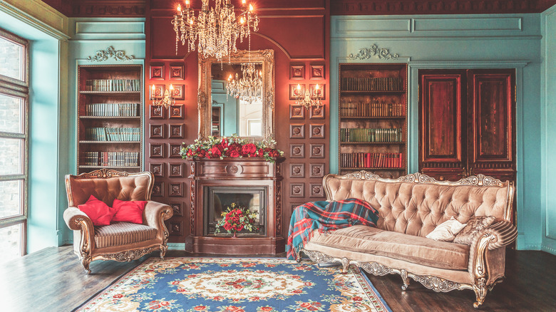 Royalcore inspired living room with tufted sofa and chandelier