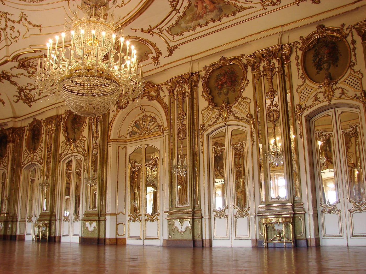 Ornate palace ballroom with gilded walls and crystal chandeliers